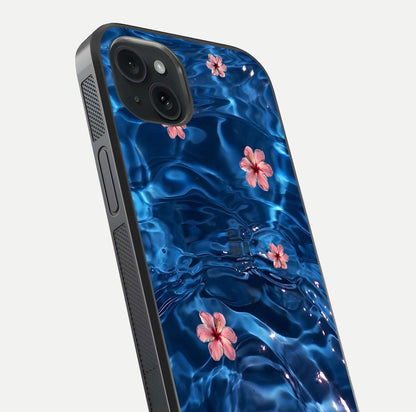 Blooming Water Drift Glass Case for iPhone 15 Plus close-up angle showing petal details, soft aqua tones, and smooth gloss reflection