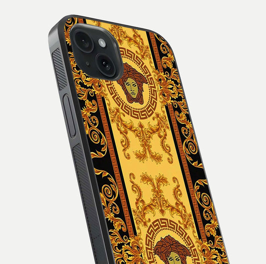 Golden Royal Heritage Glass Case for iPhone 15 Plus close-up angled shot showing intricate design and metallic reflection