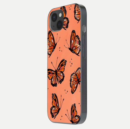 Coral Wing Butterfly Glass Case for iPhone 15 Plus side-angle photo showing reflective finish and smooth edges