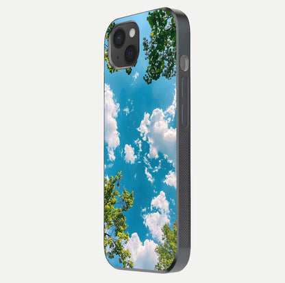 Greenery Sky Glass Case for iPhone 15 Plus side-angle image showing reflection glow and nature-themed pattern