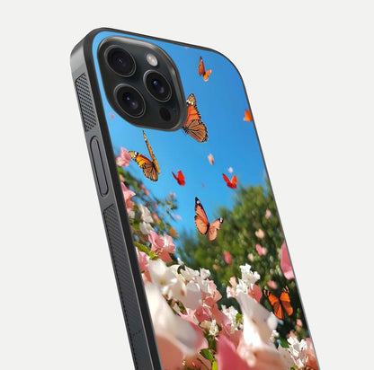 Butterflies in Bloom Sky Glass Case for iPhone 15 Pro close-up shot showing wings, petal reflections, and soft hues