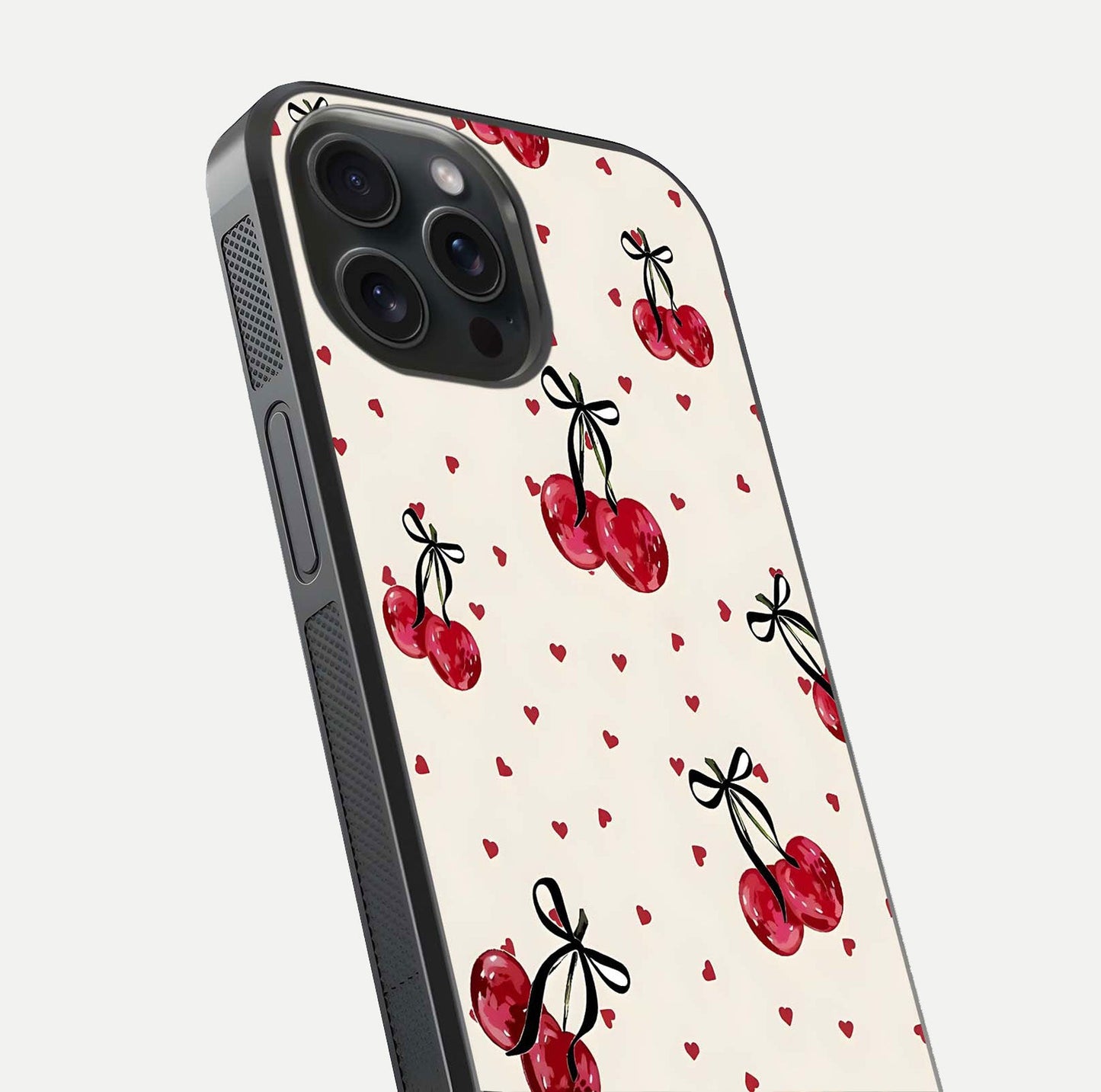 Cherry Heart Bow Glass Case for iPhone 15 Pro close-up highlighting small bows, cherry red tones, and gloss shine