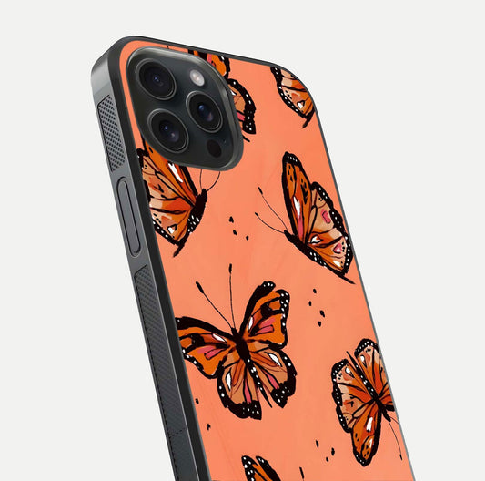 Coral Wing Butterfly Glass Case for iPhone 15 Pro close-up highlighting wing pattern, coral tones, and reflection shine