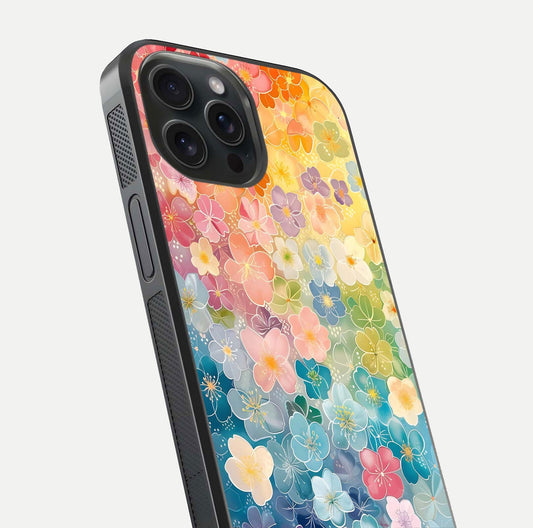 Rainbow Blossom Burst Glass Case for iPhone 15 Pro close-up angled shot showing petal colors and reflection