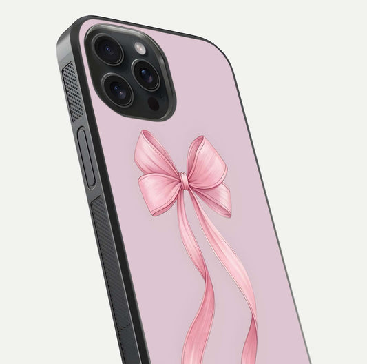 Soft Blush Bow iPhone 15 Pro glass phone case angled back view highlighting bow artwork and side grip texture