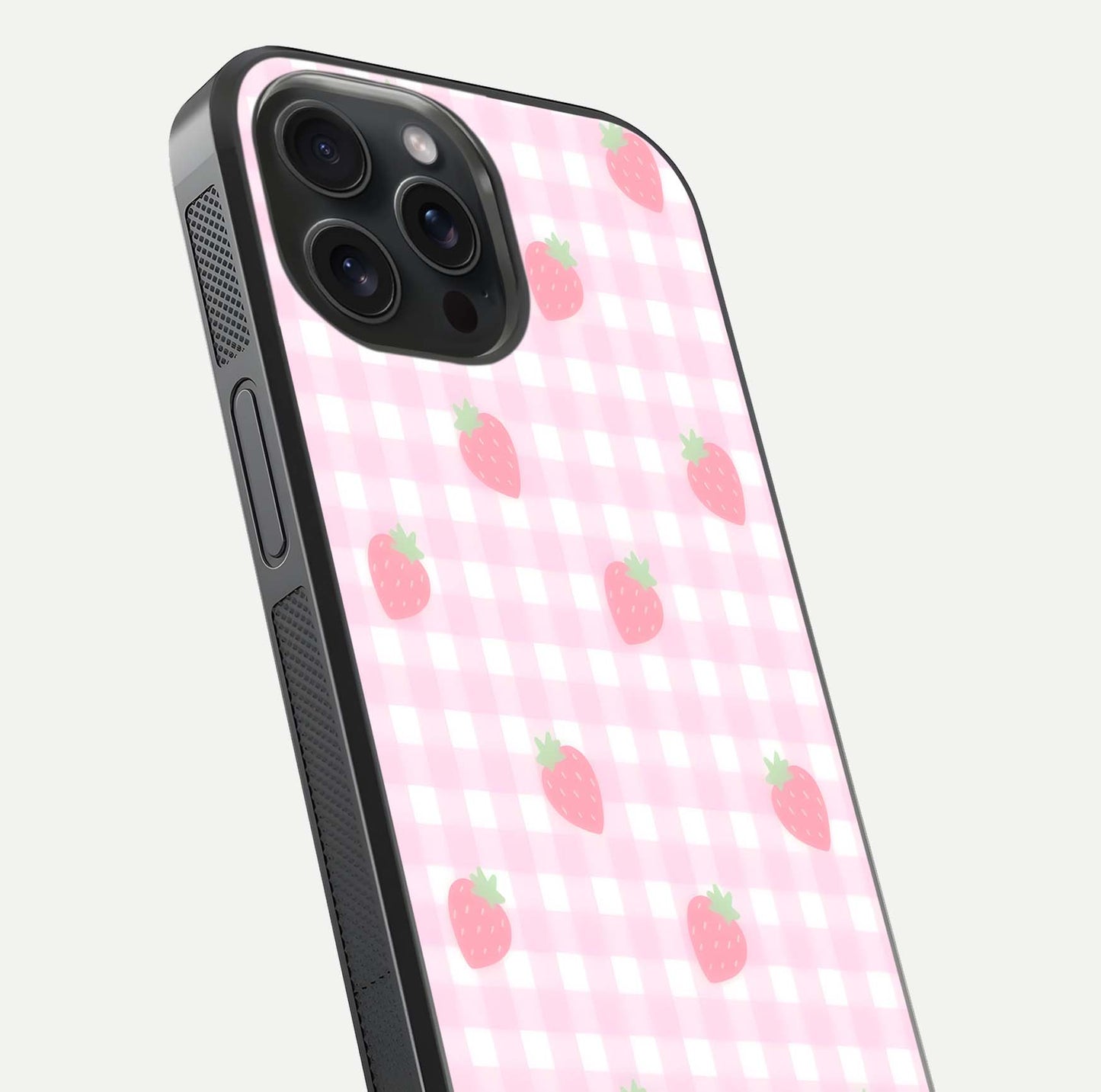 Strawberry Picnic Love iPhone 15 Pro glass phone case angled back view highlighting strawberry illustrations and textured grip
