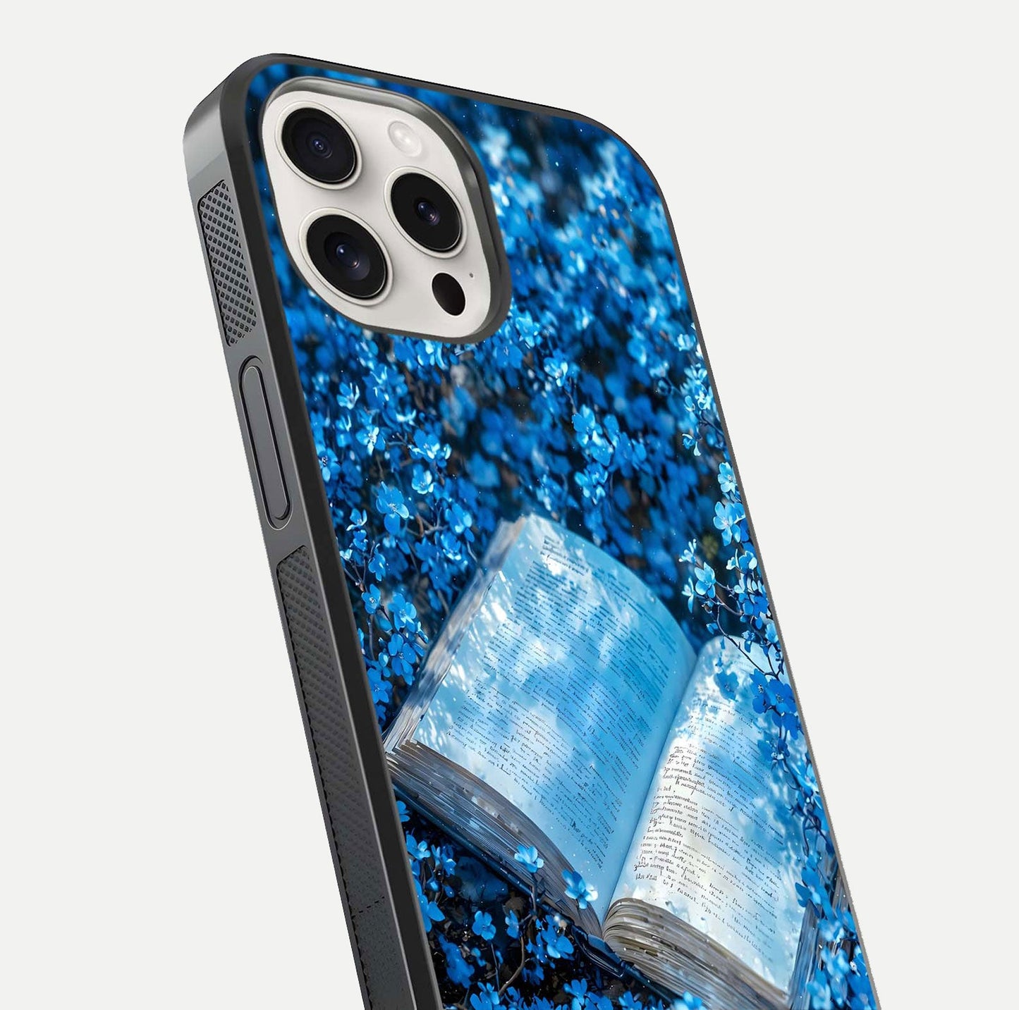 Blue Bloom Tales Glass Case for iPhone 15 Pro Max close-up angle showing petal texture and blue tone reflection