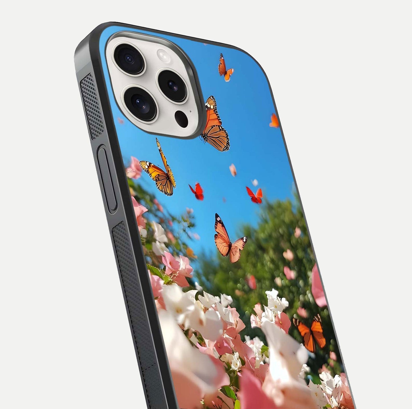 Butterflies in Bloom Sky Glass Case for iPhone 15 Pro Max close-up shot showing wings, petal reflections, and soft hues
