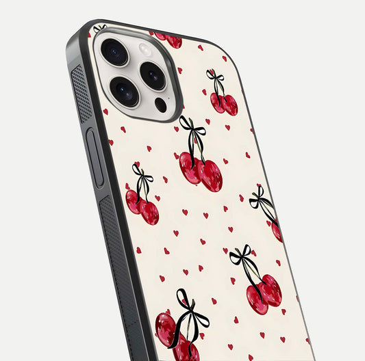 Cherry Heart Bow Glass Case for iPhone 15 Pro Max close-up highlighting small bows, cherry red tones, and gloss shine