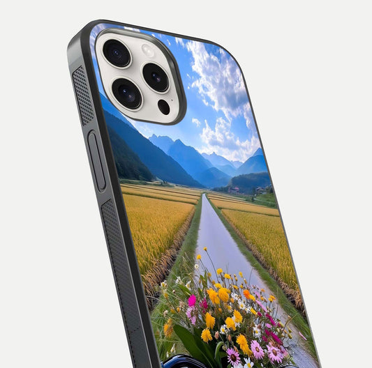 Golden Field Journey Glass Case for iPhone 15 Pro Max close-up angled shot showing sunlight tones and reflection clarity