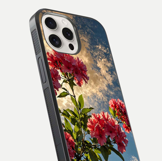 Red Bloom Skies Glass Case for iPhone 15 Pro Max close-up angled shot highlighting detailed blooms and reflection