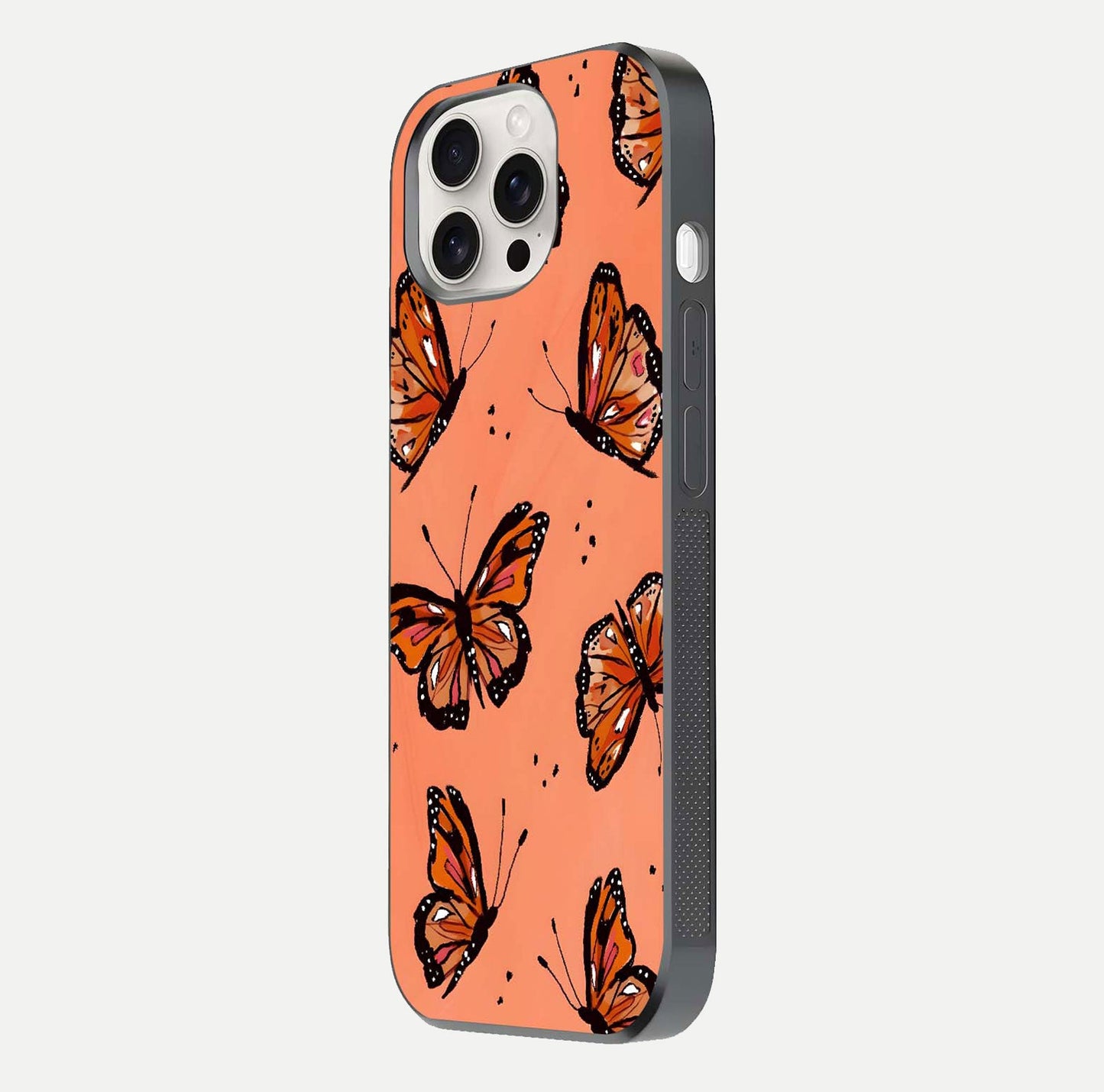 Coral Wing Butterfly Glass Case for iPhone 15 Pro Max side-angle photo showing reflective finish and smooth edges