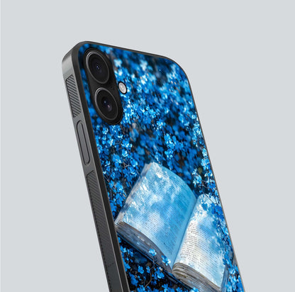 Blue Bloom Tales Glass Case for iPhone 16 close-up angle showing petal texture and blue tone reflection