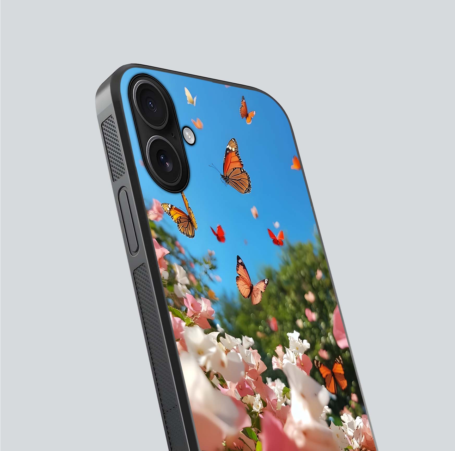 Butterflies in Bloom Sky Glass Case for iPhone 16 close-up shot showing wings, petal reflections, and soft hues
