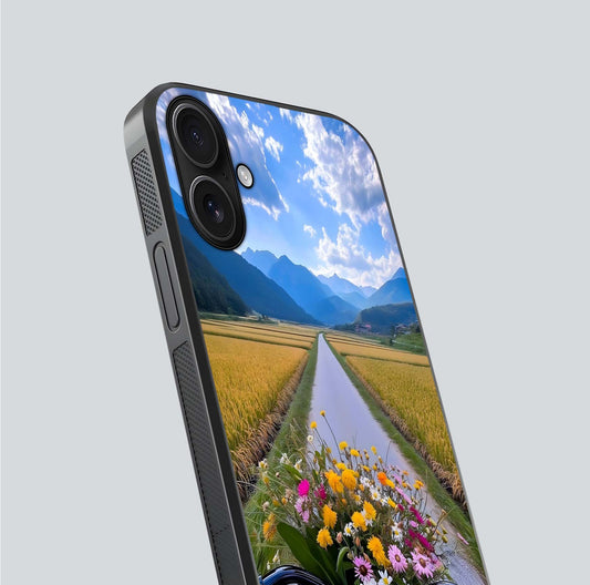 Golden Field Journey Glass Case for iPhone 16 close-up angled shot showing sunlight tones and reflection clarity