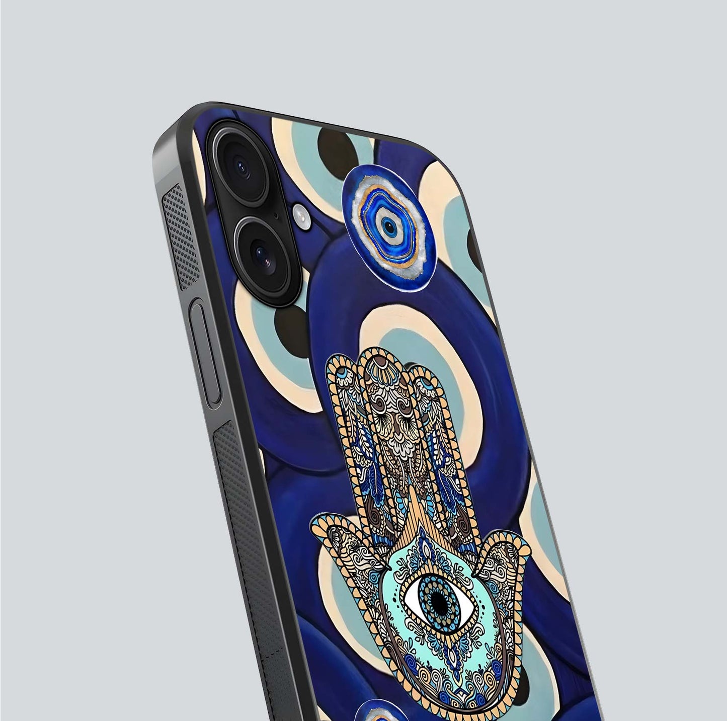 Hamsa Divine Guard Glass Case for iPhone 16 close-up angled shot showing detailed palm motif and reflection glow