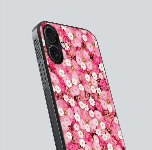 Pink Daisy Bliss Glass Case for iPhone 16 close-up angled shot highlighting daisy detail and reflection glow