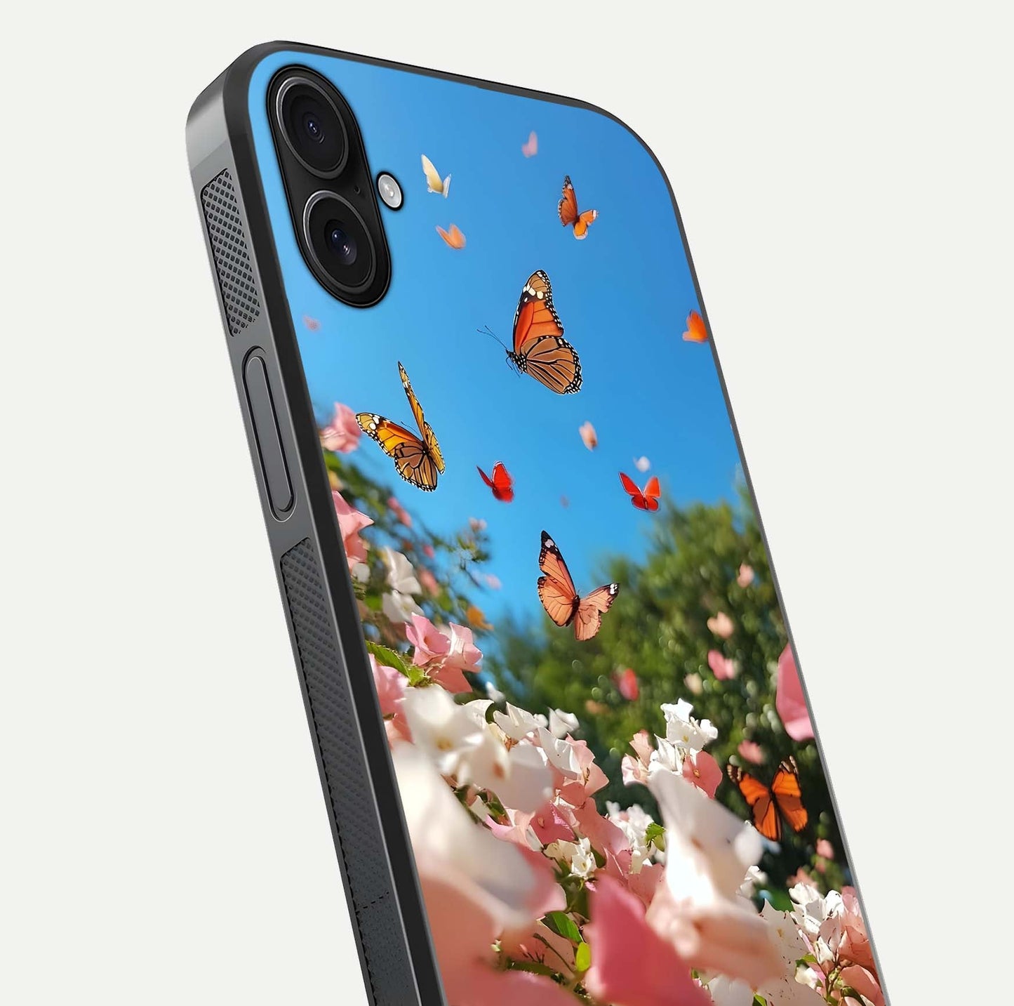 Butterflies in Bloom Sky Glass Case for iPhone 16 Plus close-up shot showing wings, petal reflections, and soft hues