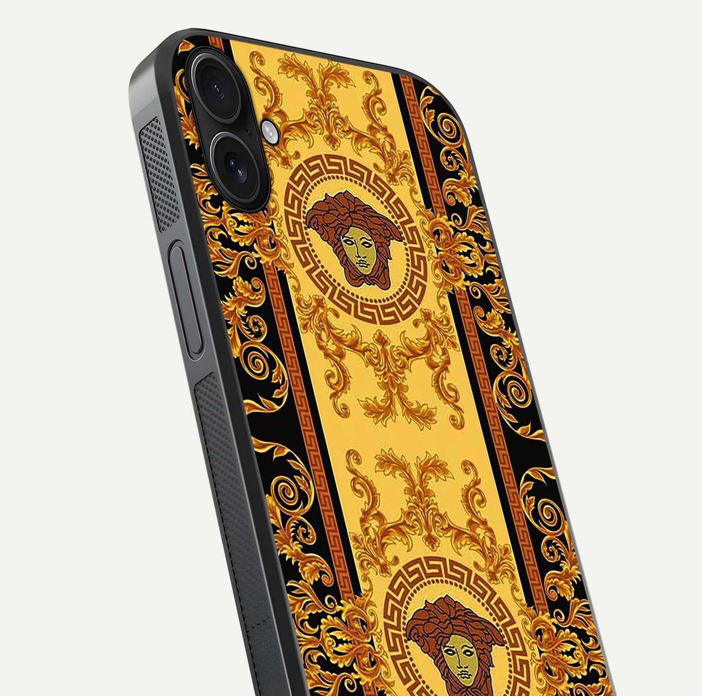 Golden Royal Heritage Glass Case for iPhone 16 Plus close-up angled shot showing intricate design and metallic reflection