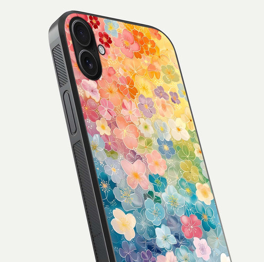 Rainbow Blossom Burst Glass Case for iPhone 16 Plus close-up angled shot showing petal colors and reflection
