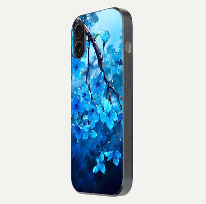 Blue Blossoms Branch Glass Case for iPhone 16 Plus side-angle image showing blossom pattern flow and glossy texture