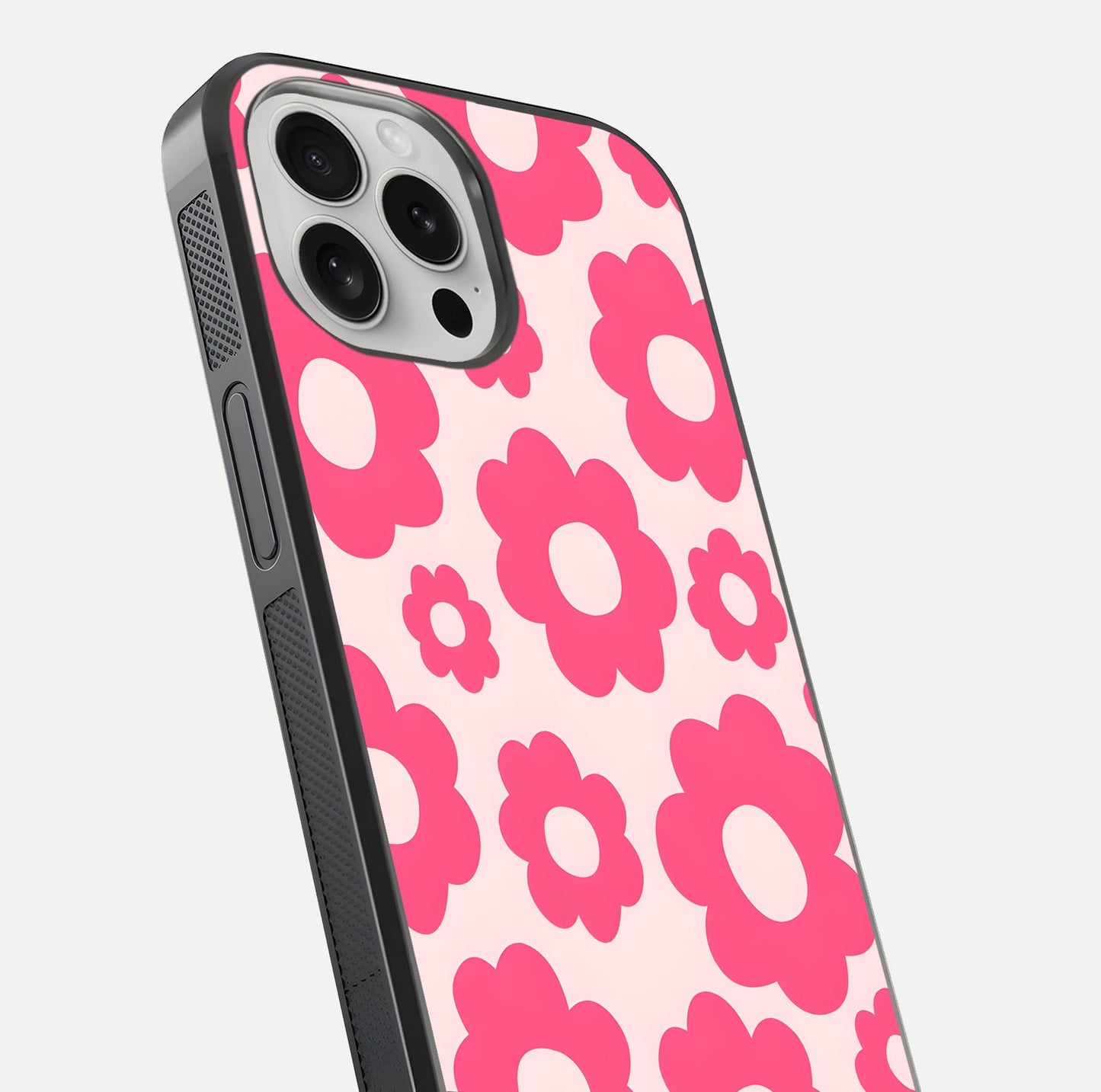 Blush Flower Pop iPhone 16 Pro glass phone case angled back view highlighting bright floral pop design and side grip texture