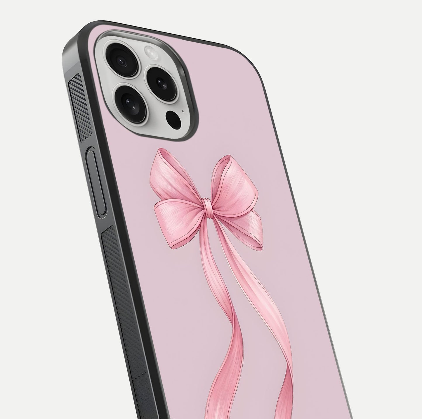 Soft Blush Bow iPhone 16 Pro glass phone case angled back view highlighting bow artwork and side grip texture