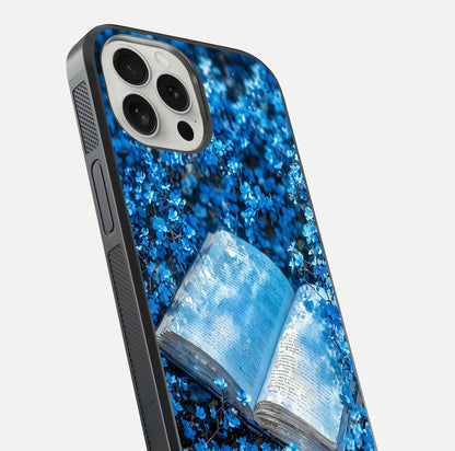 Blue Bloom Tales Glass Case for iPhone 16 Pro close-up angle showing petal texture and blue tone reflection