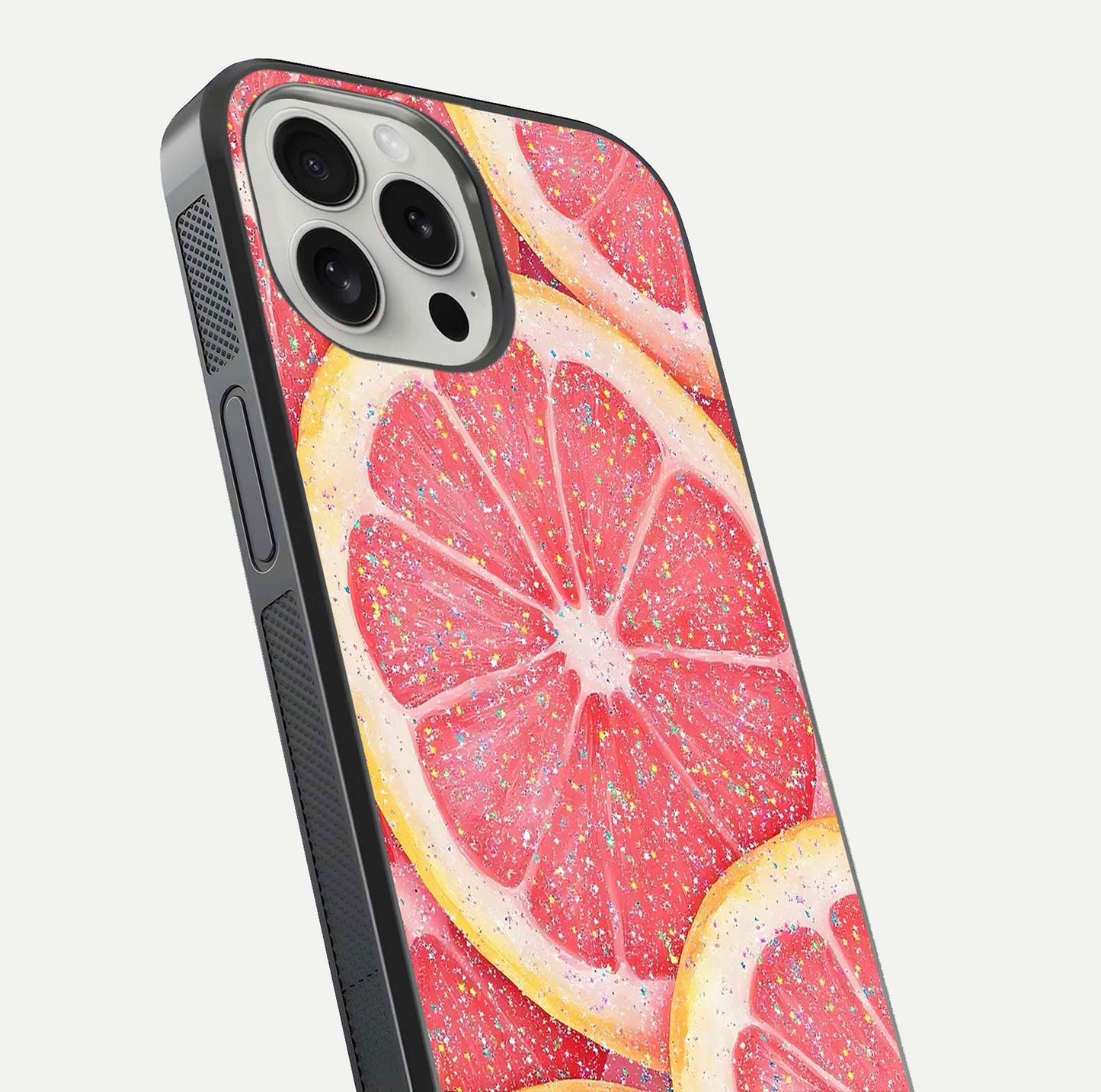 Glitter Grapefruit Glass Case for iPhone 16 Pro close-up angled shot showing fruit texture and glitter reflection