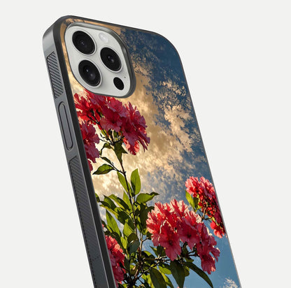 Red Bloom Skies Glass Case for iPhone 16 Pro close-up angled shot highlighting detailed blooms and reflection