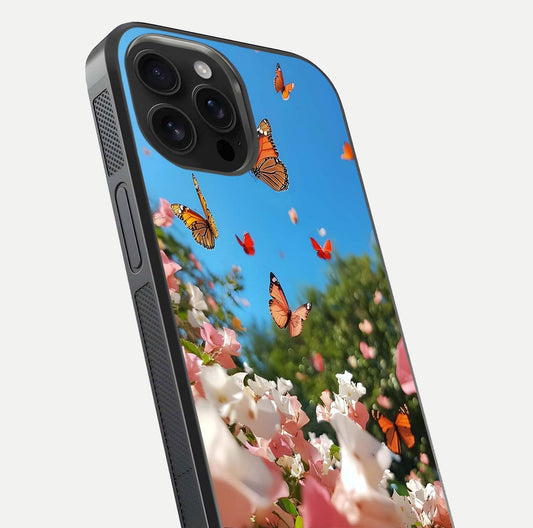 Butterflies in Bloom Sky Glass Case for iPhone 16 Pro Max close-up shot showing wings, petal reflections, and soft hues