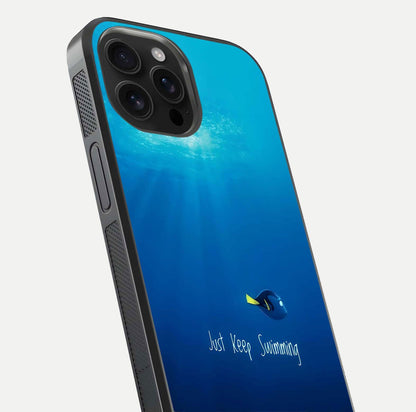 Just Keep Swimming Glass Case for iPhone 16 Pro Max close-up angled shot showing elegant lettering and blue tone reflection