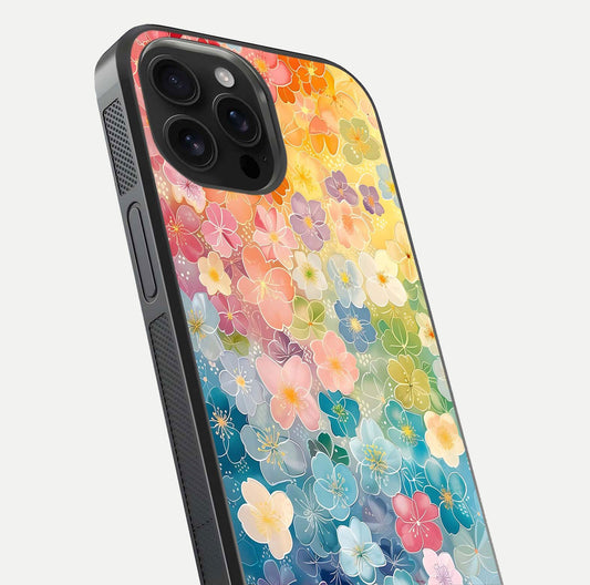 Rainbow Blossom Burst Glass Case for iPhone 16 Pro Max close-up angled shot showing petal colors and reflection