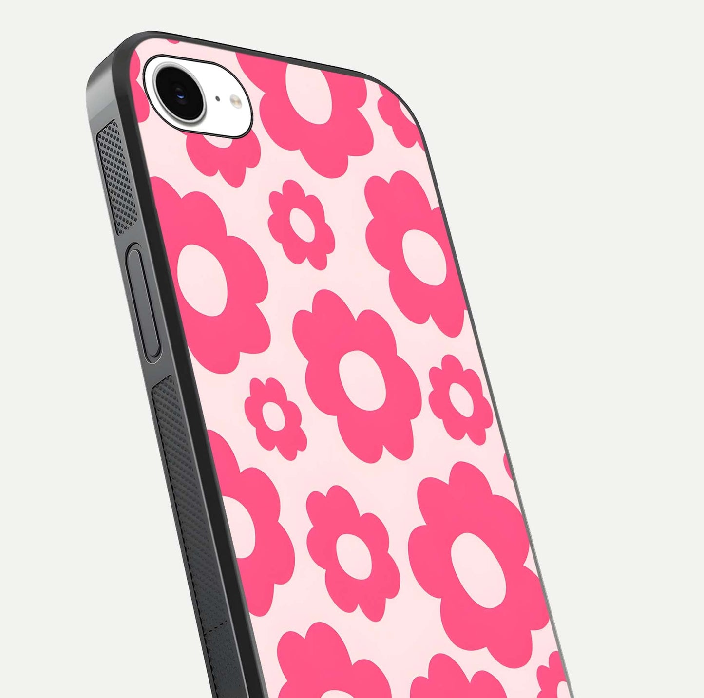 Blush Flower Pop iPhone 16e glass phone case angled back view highlighting bright floral pop design and side grip texture