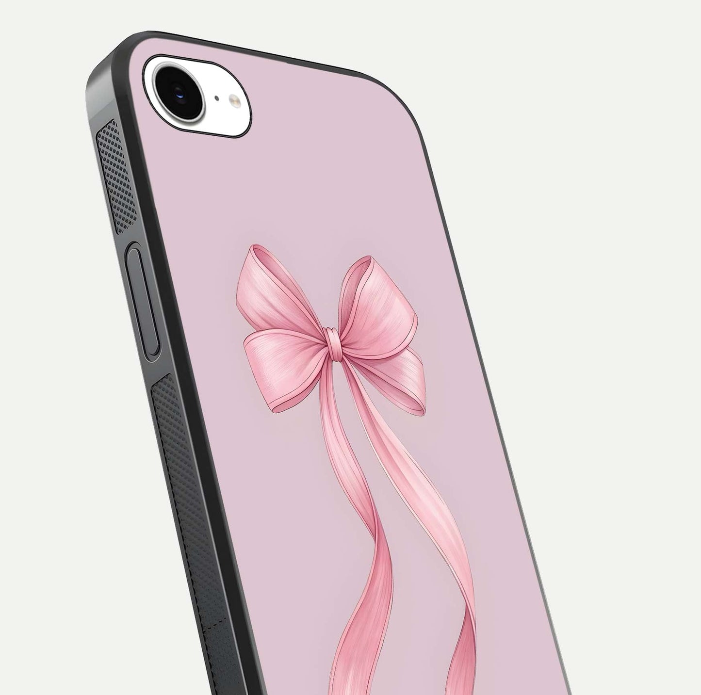 Soft Blush Bow iPhone 16e glass phone case angled back view highlighting bow artwork and side grip texture