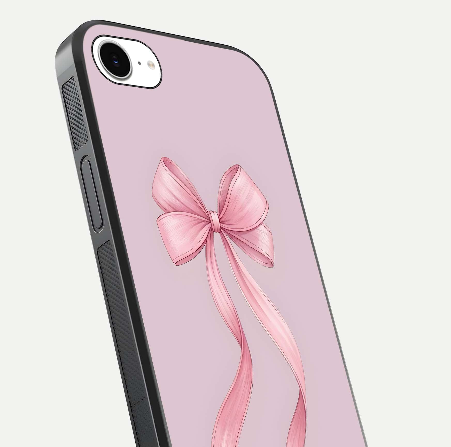 Soft Blush Bow iPhone 16e glass phone case angled back view highlighting bow artwork and side grip texture