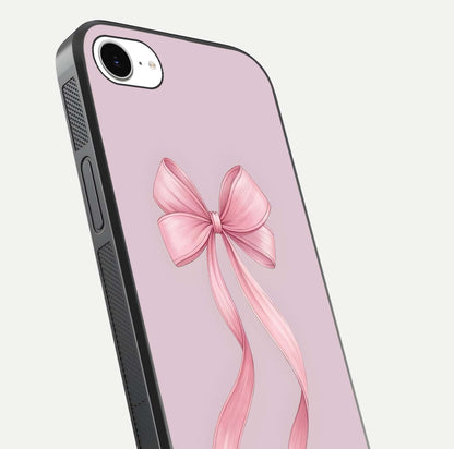 Soft Blush Bow iPhone 16e glass phone case angled back view highlighting bow artwork and side grip texture