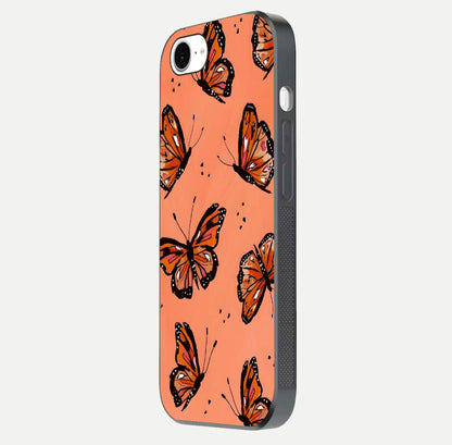 Coral Wing Butterfly Glass Case for iPhone 16e side-angle photo showing reflective finish and smooth edges