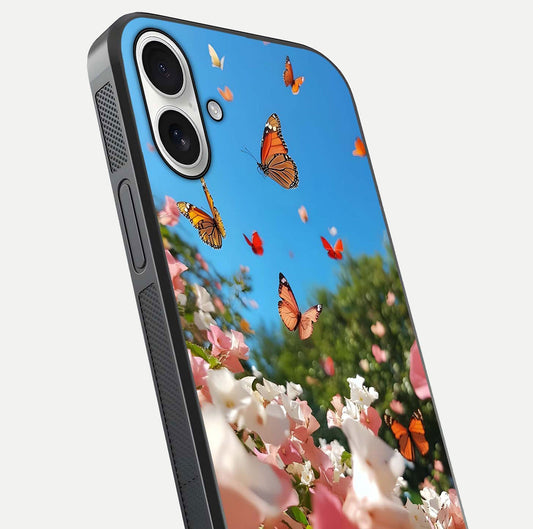 Butterflies in Bloom Sky Glass Case for iPhone 17 close-up shot showing wings, petal reflections, and soft hues