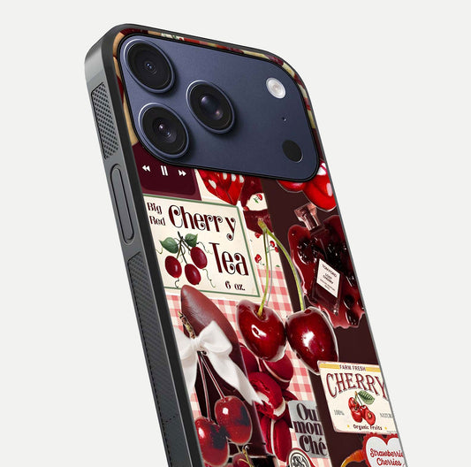 Aesthetic Cherry Tea Glass Case for iPhone 17 Pro close-up angled shot showing detailed cherry artwork, red tones, and gloss reflection