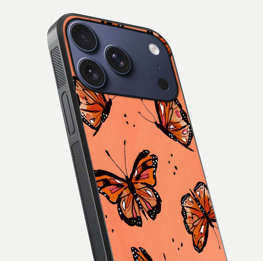 Coral Wing Butterfly Glass Case for iPhone 17 Pro close-up highlighting wing pattern, coral tones, and reflection shine