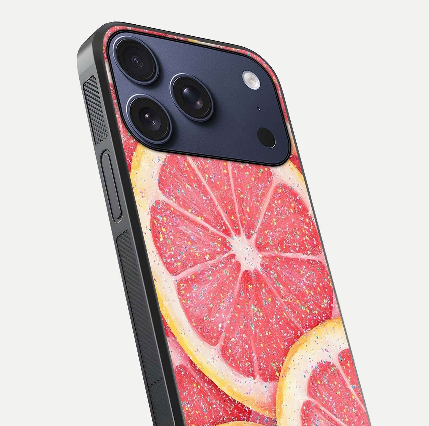 Glitter Grapefruit Glass Case for iPhone 17 Pro close-up angled shot showing fruit texture and glitter reflection