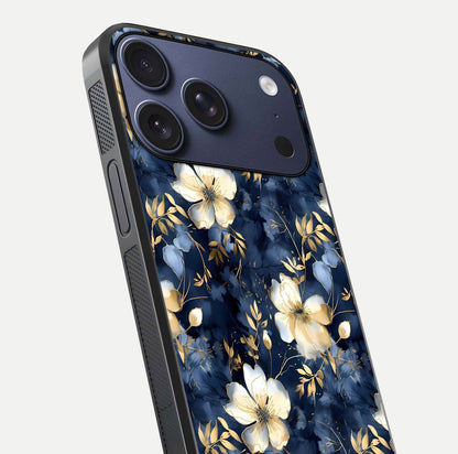 Golden Midnight Bloom Glass Case for iPhone 17 Pro close-up angled shot showing floral detail and reflection shine