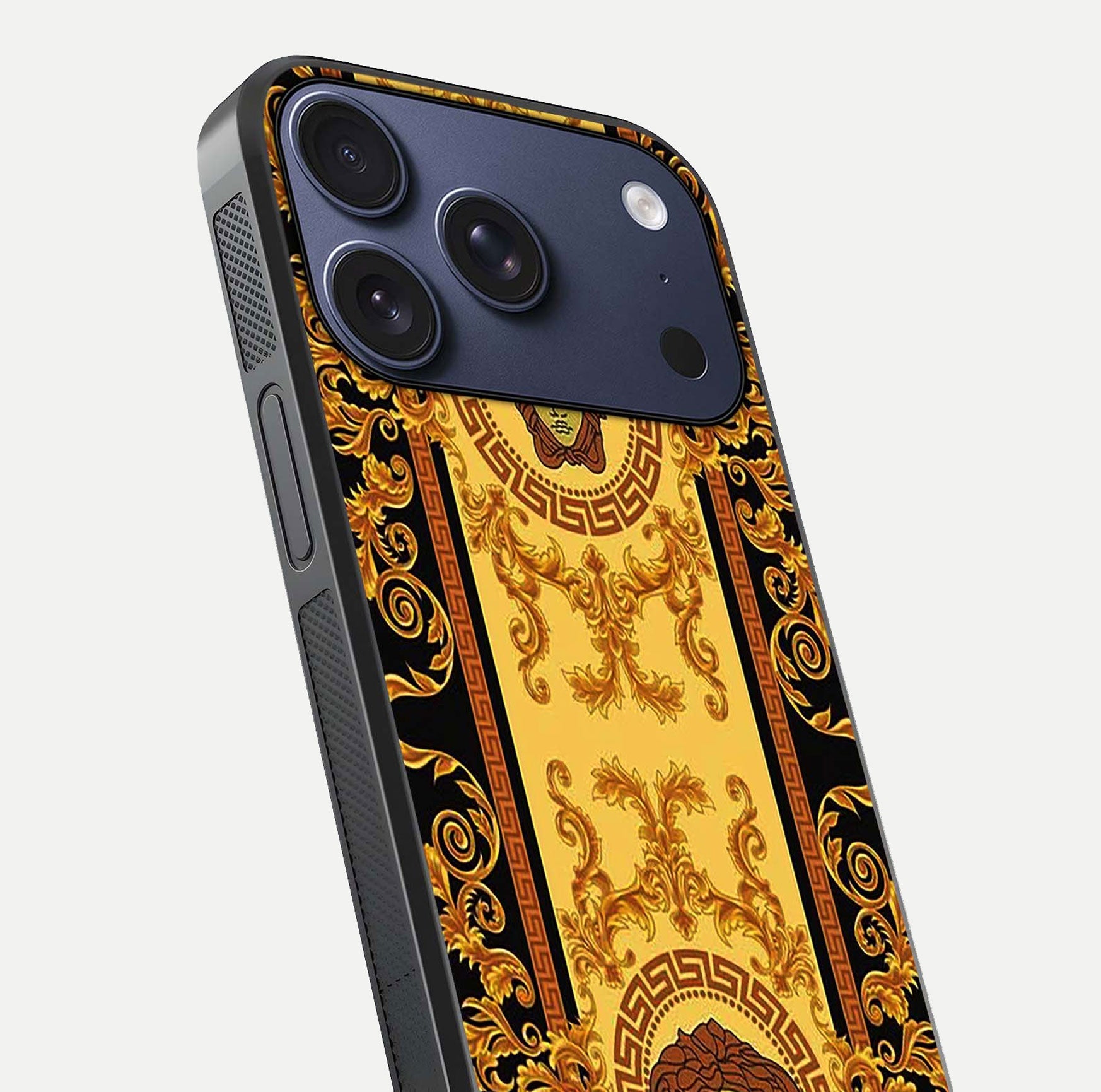 Golden Royal Heritage Glass Case for iPhone 17 Pro close-up angled shot showing intricate design and metallic reflection