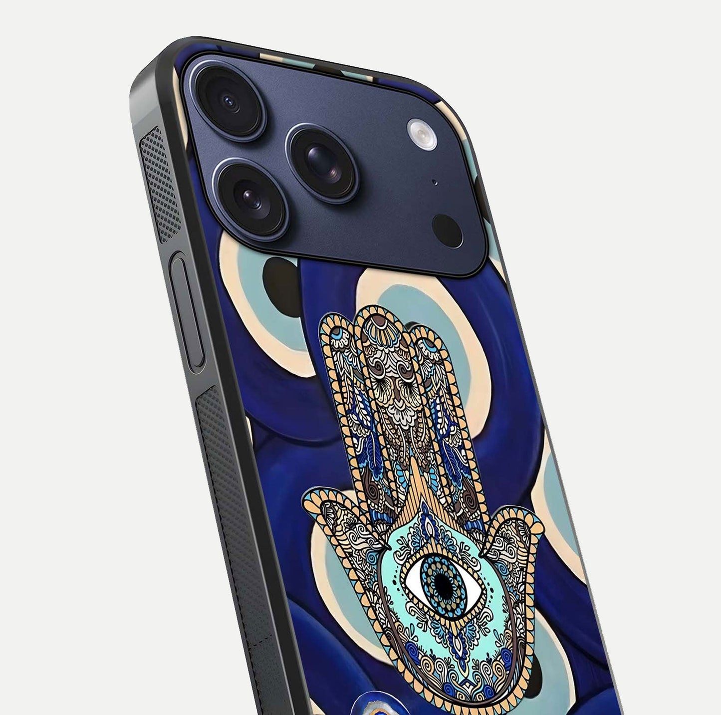 Hamsa Divine Guard Glass Case for iPhone 17 Pro close-up angled shot showing detailed palm motif and reflection glow