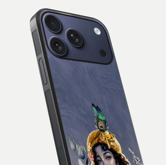 Lord Krishna Glass Case for iPhone 17 Pro angled close-up showing intricate flute and reflection details