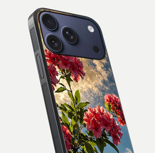 Red Bloom Skies Glass Case for iPhone 17 Pro close-up angled shot highlighting detailed blooms and reflection