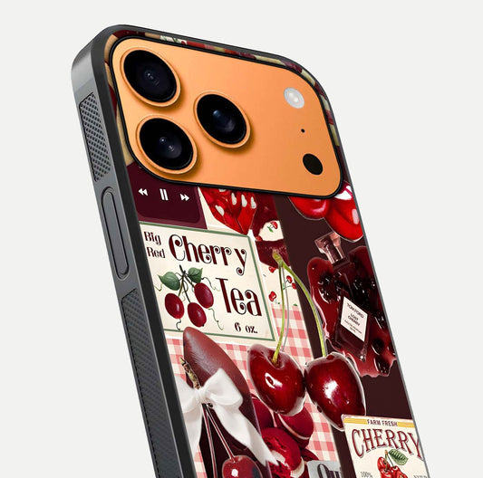 Aesthetic Cherry Tea Glass Case for iPhone 17 Pro Max close-up angled shot showing detailed cherry artwork, red tones, and gloss reflection