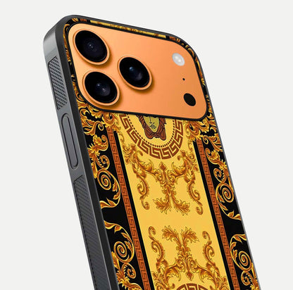 Golden Royal Heritage Glass Case for iPhone 17 Pro Max close-up angled shot showing intricate design and metallic reflection
